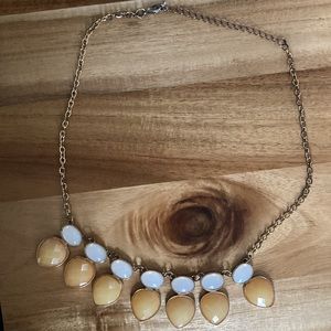 Gold tone statement necklace with peach and white faux stones